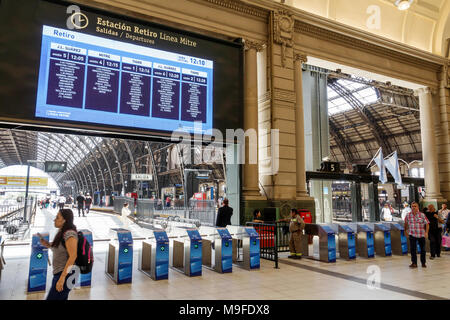 Buenos Aires Argentina,Estacion Retiro train station,platform,railway terminus,departure sign,turnstiles,interior inside,Hispanic,ARG171128125 Stock Photo