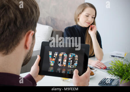 Man using digital tablet for watching movie on VOD service. Video On Demand television internet stream multimedia concept Stock Photo