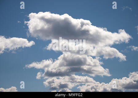 A deep blue sky with white cumulus clouds over Lake Pleasant in the Adirondack Mountains, NY USA Stock Photo