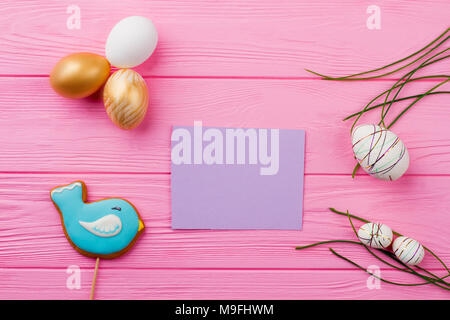 Easter festive background and blank card. Realistic and decorative Easter eggs decorated with grass. Easter decoration ideas. Stock Photo