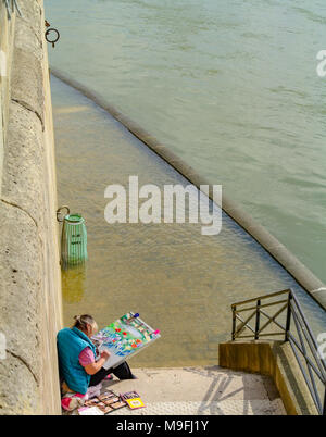 senior woma painting by seine river, Paris, France Stock Photo