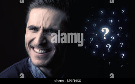 businessman with many question mark near him Stock Photo