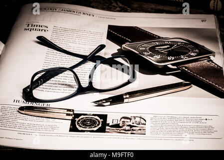 Reading glasses placed on financial newspaper Stock Photo