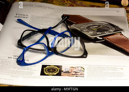 Reading glasses placed on financial newspaper Stock Photo