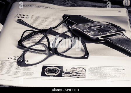 Reading glasses placed on financial newspaper Stock Photo