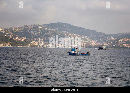 Small traditional fishing boat on Bosphorus strait in Istanbul. Stock Photo