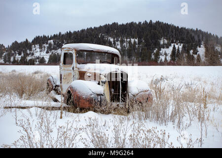 A 1937 Chevrolet pickup truck rat rod in a snow-covered landscape near Silver Lake Montana. Stock Photo