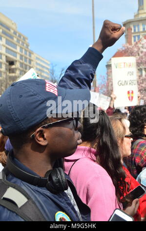 Washington, DC, USA. 24th Mar, 2018. A young African American man raises his hand in support of the March for our Lives in Washington, DC Credit: James Kirkikis/Alamy Live News Stock Photo