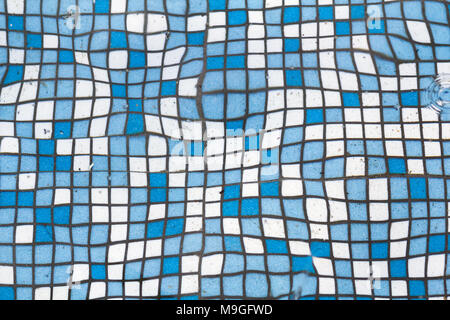 Close up picture of small square blue and white shiny ceramic tiles. Background, bathrooms and pools walls and floor design. Stock Photo