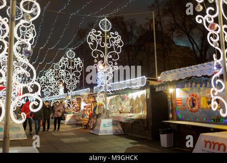 St. Petersburg, Russia - December 23, 2015: People at the Christmas Fair on the Pionerskaya square. Visitors can buy food and souvenirs from various r Stock Photo