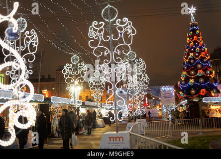 St. Petersburg, Russia - December 23, 2015: People at the Christmas Fair on the Pionerskaya square. Visitors can buy food and souvenirs from various r Stock Photo