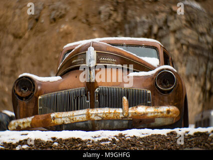 The front of an old, rusty 1941 Studebaker Champion sedan, in a stone quarry, east of Clark Fork Idaho. Stock Photo