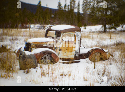 A 1937 Chevrolet pickup truck rat rod in a snow-covered landscape near Silver Lake Montana. Stock Photo