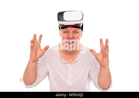 Angry man with glasses or a helmet of virtual reality on his head on a white. Stock Photo
