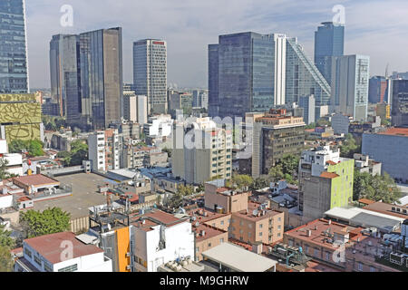 The distant skyscrapers of the Finance District in Mexico City, Mexico tower over the neighboring Zona Rosa neighborhood in the foreground. Stock Photo