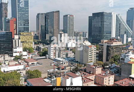 The distant skyscrapers of the Finance District in Mexico City, Mexico tower over the neighboring Zona Rosa neighborhood in the foreground. Stock Photo