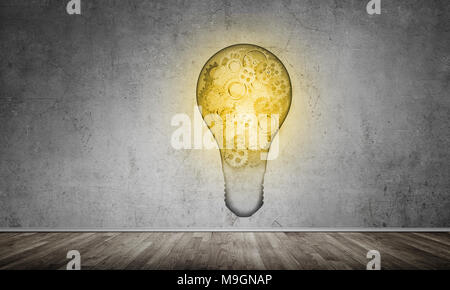 Glass lightbulb with multiple gears inside placed in empty room with grey wall on background. 3D rendering. Stock Photo