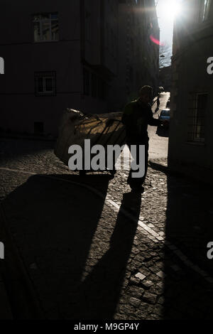 Istanbul, Turkey - March 15, 2018 : A paper collector man is pulling a whellbarrow at Istanbul, Balat District. Also there are effective shadows. Stock Photo
