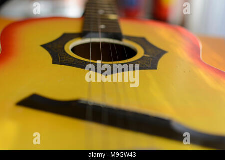 blurry out of focus image of Acoustic guitar with musical notes on