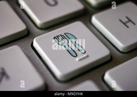 Image of fork and knife on computer keyboard, food delivery service internet Stock Photo