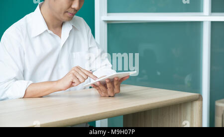 businessman using tablet computer on desk at office,after working at evening Stock Photo