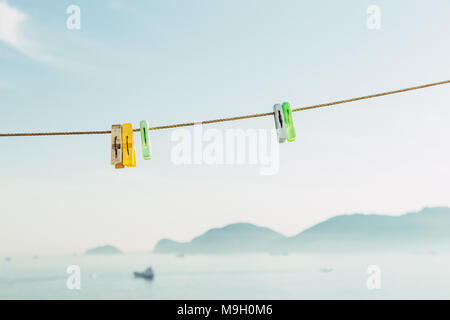 Colorful clothes pegs on the blue sky Stock Photo