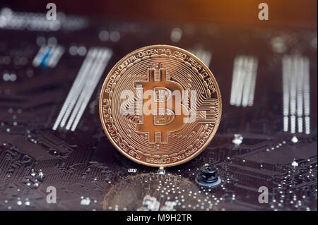 Bitcoin gold coin and defocused chart background. Virtual cryptocurrency concept Stock Photo