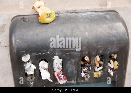 An outdoor ashtray that has been used for litter as well as cigarette ends. London England UK GB Stock Photo