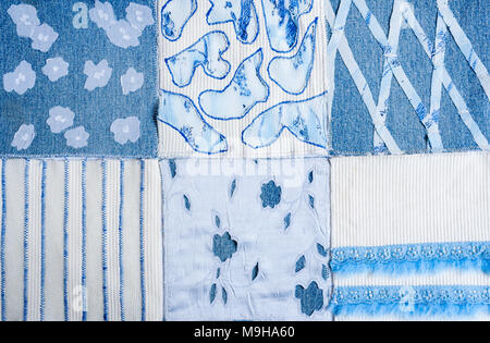 Textile background from square samples of hand-made fabrics. Stock Photo
