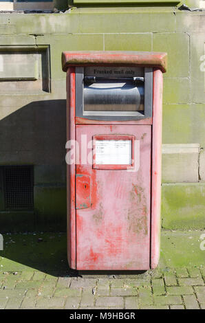 Faded Royal Mail post box for franked mail Stock Photo