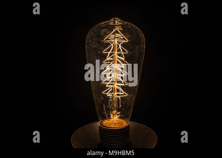Vintage incandescent light bulb filament on black.