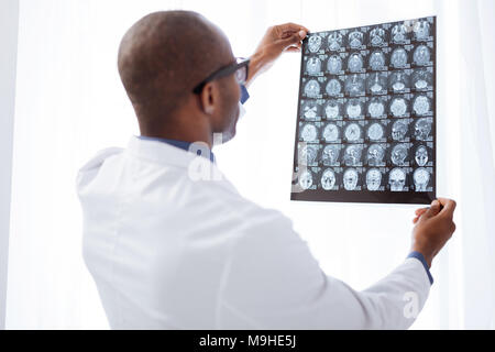 Appealing male doctor evaluating brain imaging Stock Photo
