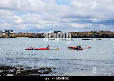 Kayakers kayaking in sea kayaks in Borthwen bay. Rhoscolyn, Holy Island, Isle of Anglesey, North Wales, UK, Britain Stock Photo