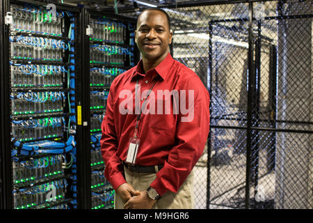 Black man technician in a computer server farm. Stock Photo