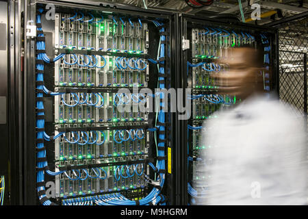 Black man technician doing diagnostic tests  on computer servers in server farm. Stock Photo