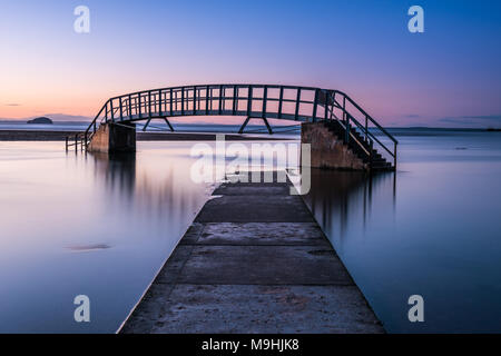 This bridge is known as 'The Bridge To Nowhere' and was built as part of Dunbar's Victorian beach improvement scheme at Belhaven Bay Stock Photo