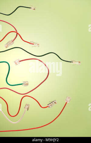 Computer net cables and telephone jack on a green background Stock Photo