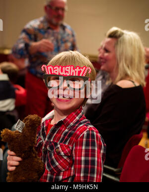Ralph aged 6, model released, wearing his 'Naughty' glasses at a Christmas Pantomime in Suffolk England UK. 26 Dec 2017 Stock Photo