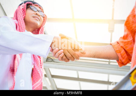 Successful Arab  emirates businessman shaking hands over a deal Stock Photo