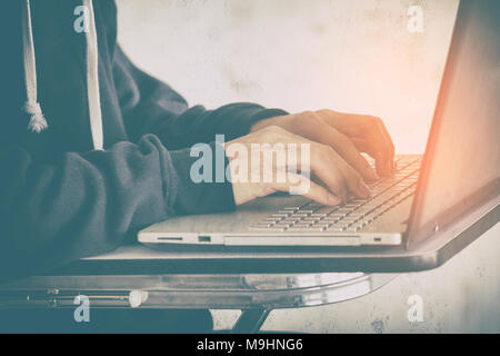 Hacker using laptop stealing data,concept for network security and cyber attack. Stock Photo