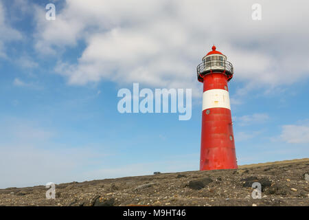 Red and white lighthouse near the town of Westkapelle near the north sea on Walcheren, Zeeland, The Netherlands. Photo taken on March 24, 2018 Stock Photo