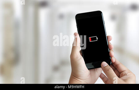Close up man hands using smart phone battery low charged battery screen Stock Photo