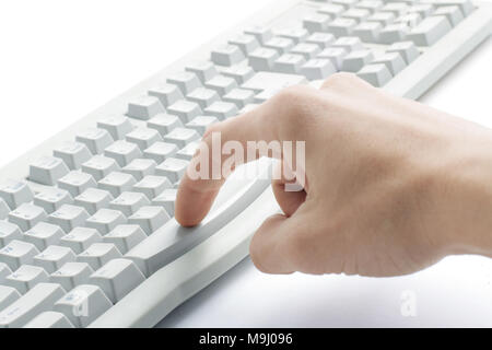 finger hit the button on the old computer keyboard Stock Photo