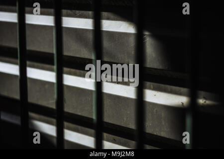 Abstract background of metal bar casting shadow on dark surface Stock Photo