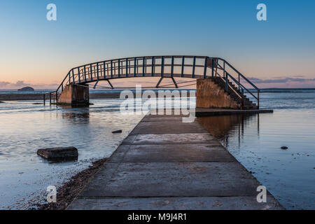 This bridge is known as 'The Bridge To Nowhere' and was built as part of Dunbar's Victorian beach improvement scheme. It crosses Biel Water where it f Stock Photo