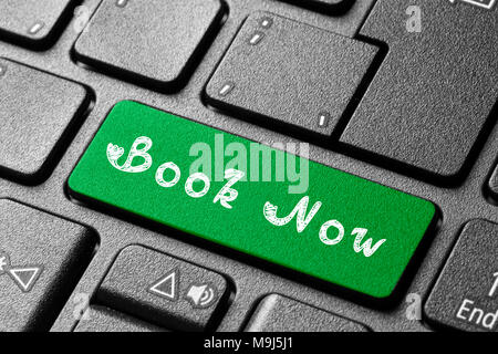 Written word Book Now on blue keyboard button Stock Photo