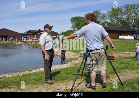 Genoa National Fish Hatchery manager, Doug Aloisi, is interviewed by a local TV station about the 9th Annual Kid's Fishing Day. Stock Photo