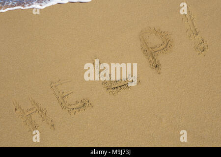 Help Sign on the beach Stock Photo