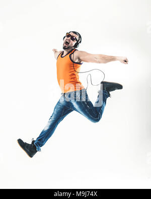 emotional and charming guy - rapper in headphones takes the dance Stock Photo
