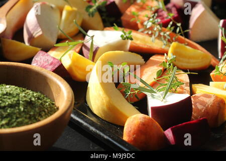 Pan full of fall seasonal vegetables ready to be grilled over a dark background Stock Photo